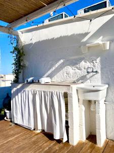 een wit huis met een wastafel en een wastafel bij Amalfi Pool Suite - Puglia Mia Apartments in Monopoli
