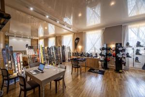 a room with a table and a bunch of skis at Best Western Grand Hotel de Bordeaux in Aurillac +62 photos