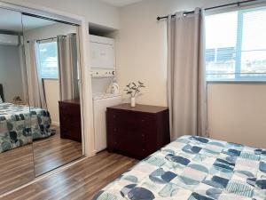 a bedroom with a bed and a dresser and a mirror at Redwood Place in Heart of Silicon Valley in Sunnyvale