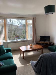 a living room with a couch and a coffee table at The Waterside Apartment 6 in Largs