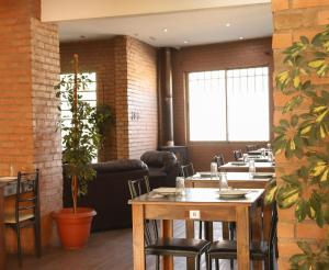 a dining room with tables and chairs and plants at Hotel Terramar in Talcahuano +31 photos