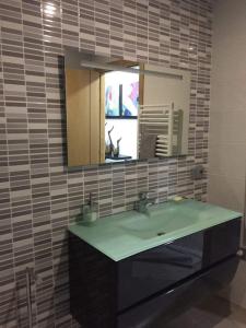 a bathroom with a sink and a mirror at CasaMesquita in Cabeceiras de Basto