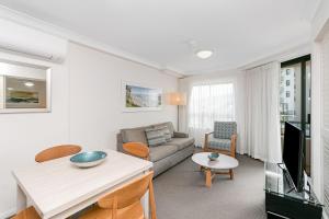 a living room with a couch and a table at Calypso Plaza Resort Unit 306 in Gold Coast