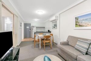 a living room with a couch and a table at Calypso Plaza Resort Unit 306 in Gold Coast