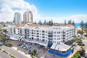 an aerial view of a large white building with a parking lot at Calypso Plaza Resort Unit 306 in Gold Coast