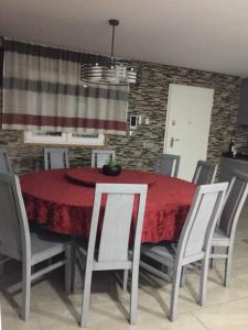 a dining room with a red table and chairs at CasaMesquita in Cabeceiras de Basto