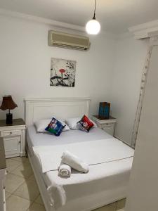 a bedroom with a white bed with two pillows at Delta Sharm Apartment 156 flat 102 in Sharm El Sheikh