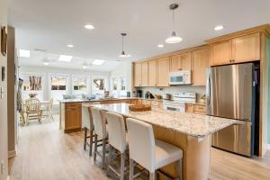 a kitchen with a large island with bar chairs at Bayberry Woods --- 744 Bayberry Circle in Bethany Beach