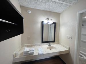 a bathroom with a sink and a mirror at Knights Inn Ashland in Ashland