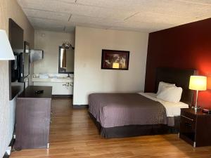 a hotel room with a bed and a kitchen at Knights Inn Ashland in Ashland