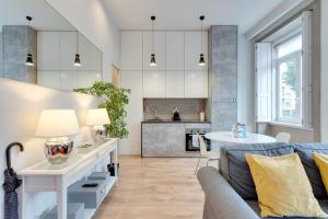 a living room with a couch and a table at Tiara Downtown Apartments by DA'HOME in Porto