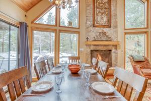 a dining room with a table and a fireplace at Yankee Mountain 9 - Meredith Lodging in Sunriver
