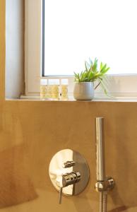 a bathroom sink with a faucet next to a window at Tiara Downtown Apartments by DA'HOME in Porto