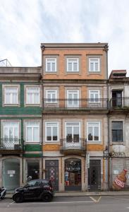 a black car parked in front of a building at Tiara Downtown Apartments by DA'HOME in Porto