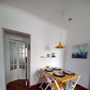 uma sala de jantar com uma mesa com pratos em Solar Canto do Forte na Praia Grande