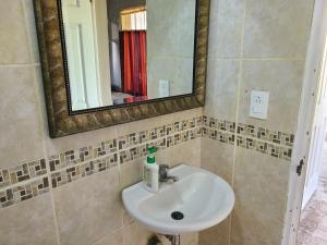 a bathroom with a sink and a mirror at Sophie House in Moyogalpa