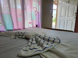 a bed with two towels on top of it at Sophie House in Moyogalpa