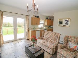 a living room with a couch and a table at Shandrum Brook in Killare