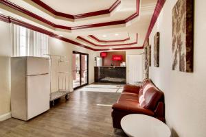 a living room with a couch and a table at Red Roof Inn & Suites Pensacola-NAS Corry in Pensacola