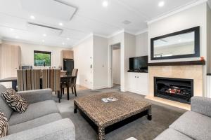 a living room with a couch and a fireplace at Cardrona Cottage - Cardrona Holiday Home in Cardrona