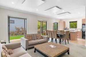 a living room with a couch and a table at Cardrona Cottage - Cardrona Holiday Home in Cardrona