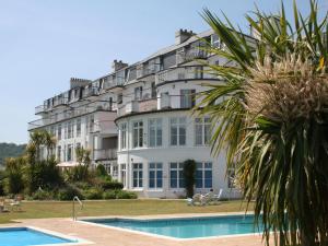 a large white building with a pool in front of it at 35 The Salcombe in Salcombe