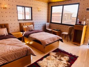 a bedroom with two beds and a window at Rum Magic Nights in Wadi Rum