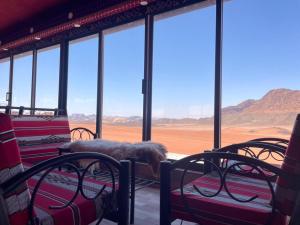 a room with chairs and a view of the desert at Rum Magic Nights in Wadi Rum