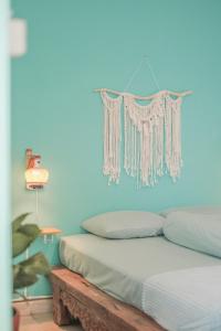 a bedroom with two beds and a blue wall at Abrakadabra 747 in Timuran