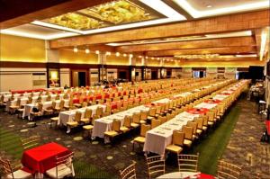 a large banquet hall with white tables and chairs at L'Fisher Hotel Bacolod in Bacolod