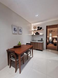 a kitchen and dining room with a wooden table and chairs at Tagaytay Country Hotel in Tagaytay