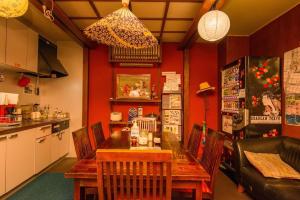 a kitchen with a wooden table and chairs at Khaosan Tokyo Kabuki in Tokyo