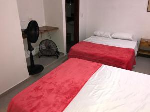 Postel nebo postele na pokoji v ubytování Hotel Buganvilla
