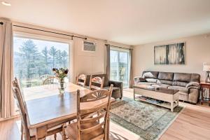 a living room with a table and a couch at Mountain Condo with Views Near Hiking and Biking! in Stowe