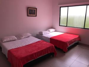 Postel nebo postele na pokoji v ubytování Hotel Buganvilla