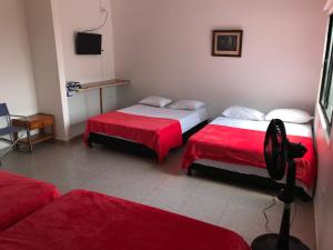 Postel nebo postele na pokoji v ubytování Hotel Buganvilla