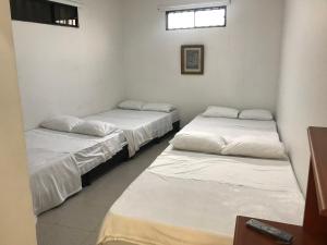 Postel nebo postele na pokoji v ubytování Hotel Buganvilla