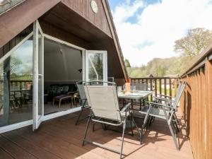 a patio with a table and chairs on a deck at Valley Lodge 52 in Callington