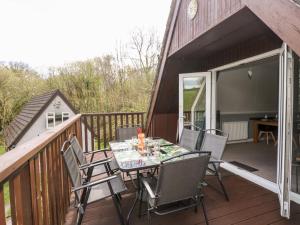 a patio with a table and chairs on a deck at Valley Lodge 52 in Callington