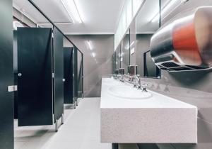 a bathroom with three sinks and a large mirror at Maze Backpackers - Sydney in Sydney