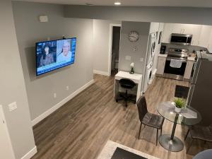 a living room with a flat screen tv on a wall at Hamm Suite in Saskatoon