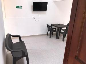 TV a/nebo společenská místnost v ubytování Hotel Buganvilla