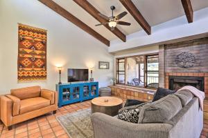 a living room with a couch and a fireplace at Beautiful Saguaro Vista with Mountain Views! in Tucson