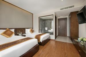 Postelja oz. postelje v sobi nastanitve Cosmos Hotel Danang