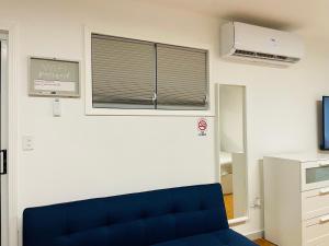 a room with a blue couch and a window at Holly Bunker in Yabucoa