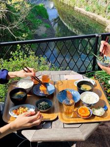 a wooden table with bowls of food on it at Children's cafe B&B Kimie in Kamakura