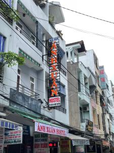 a building with an orange sign on the side of it at Anh Xuan Guest House in Hue