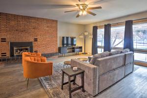 a living room with a couch and a fireplace at Sleek Deadwood Getaway Less Than 1 Mi to Downtown! in Deadwood