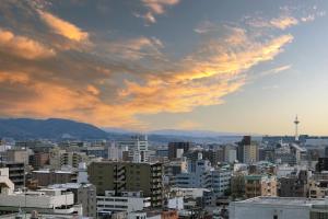 una ciudad bajo un cielo nublado con edificios en HOTEL MYSTAYS Kyoto Shijo, en Kioto