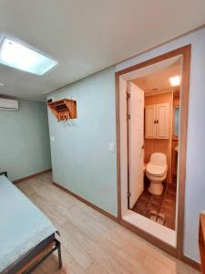 a bathroom with a toilet in a room at Guesthouse The Hill in Seoul